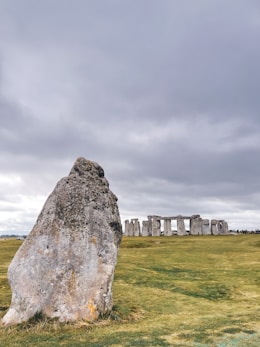 a large rock in the middle of a field