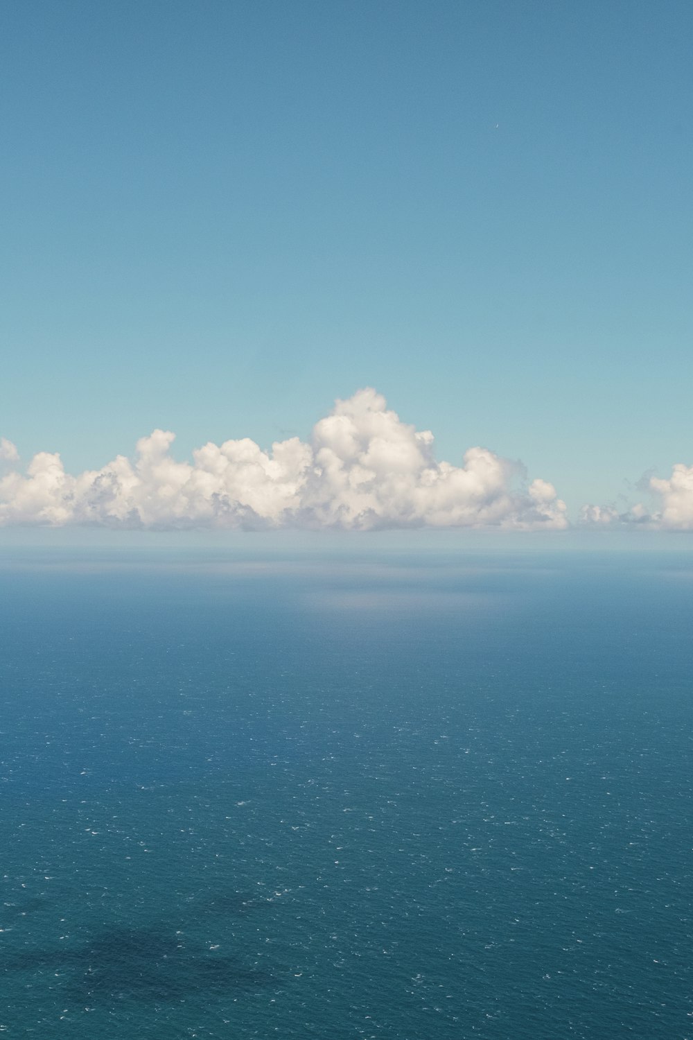 a large body of water surrounded by clouds