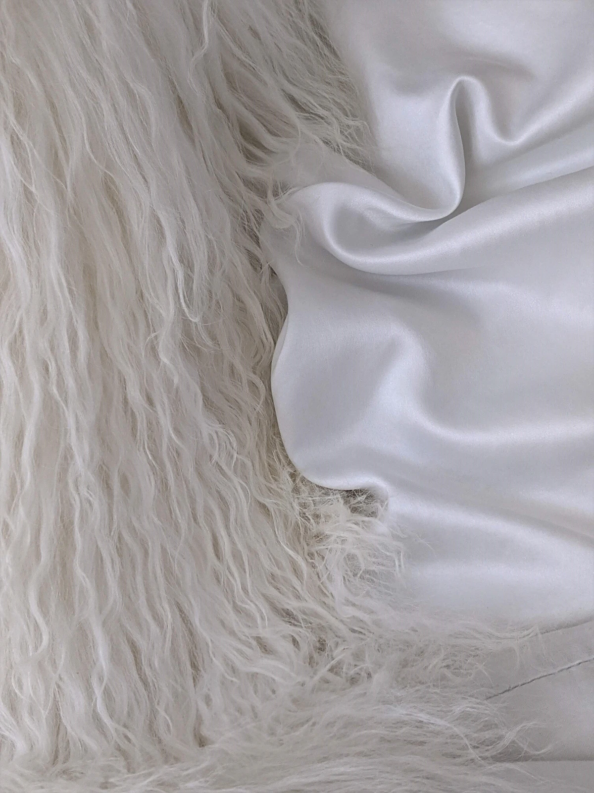 Close-up of soft white cashmere fiber resembling the fine undercoat harvested from Inner Mongolian goats
