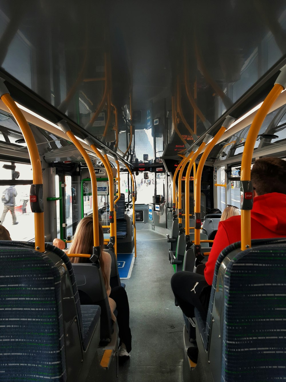 a group of people sitting on a bus next to each other