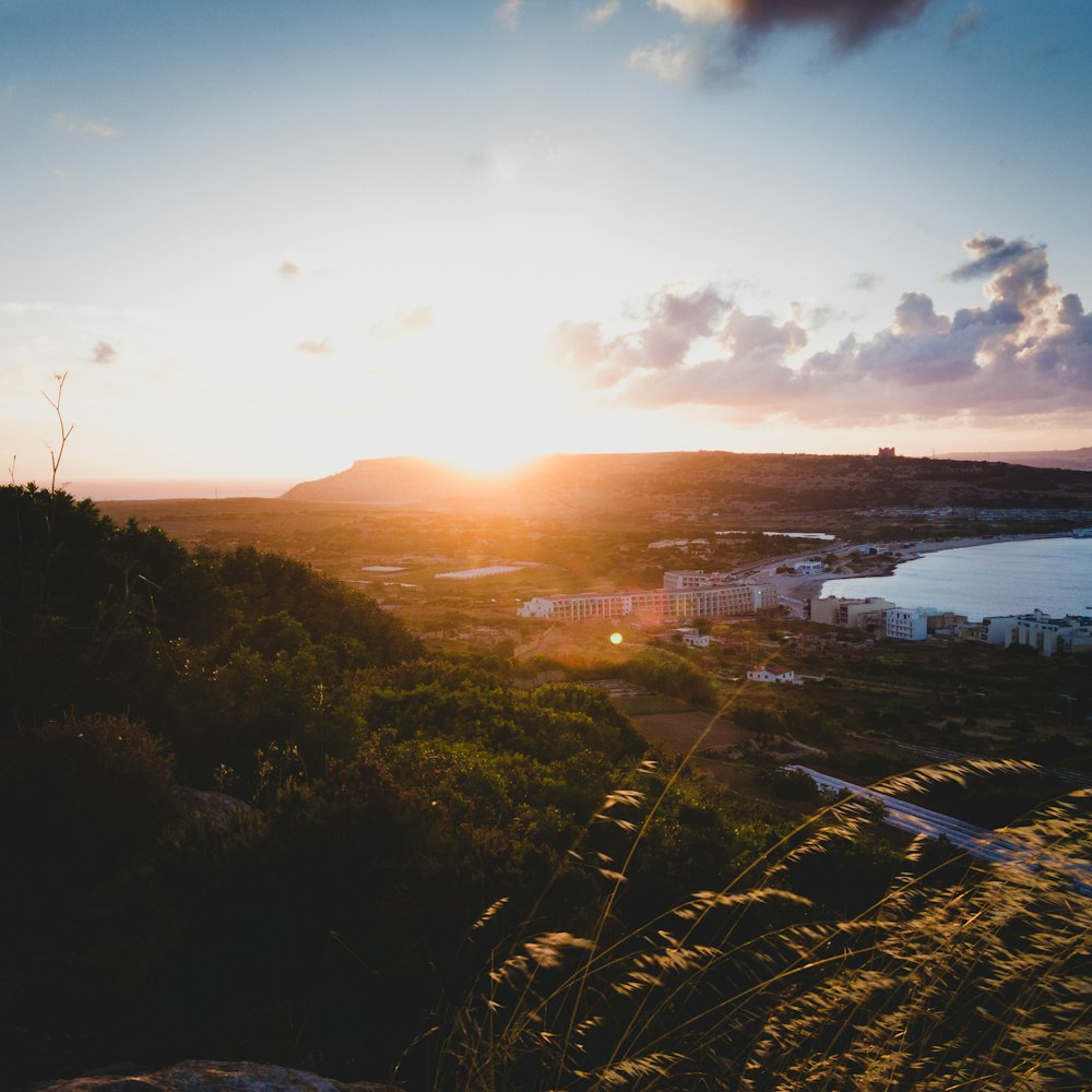 the sun is setting over a small town