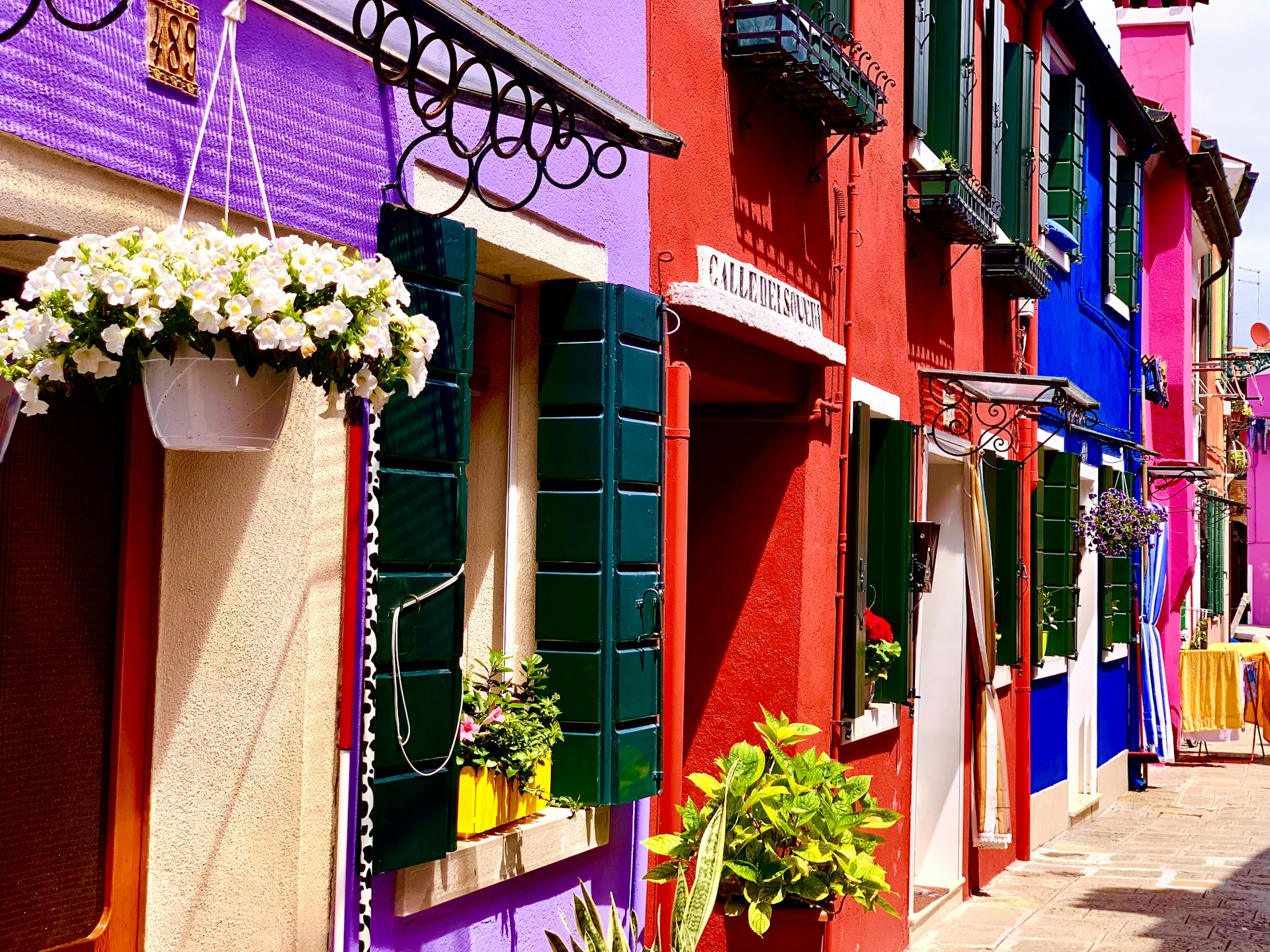 a row of colorful buildings with flower boxes on the windows