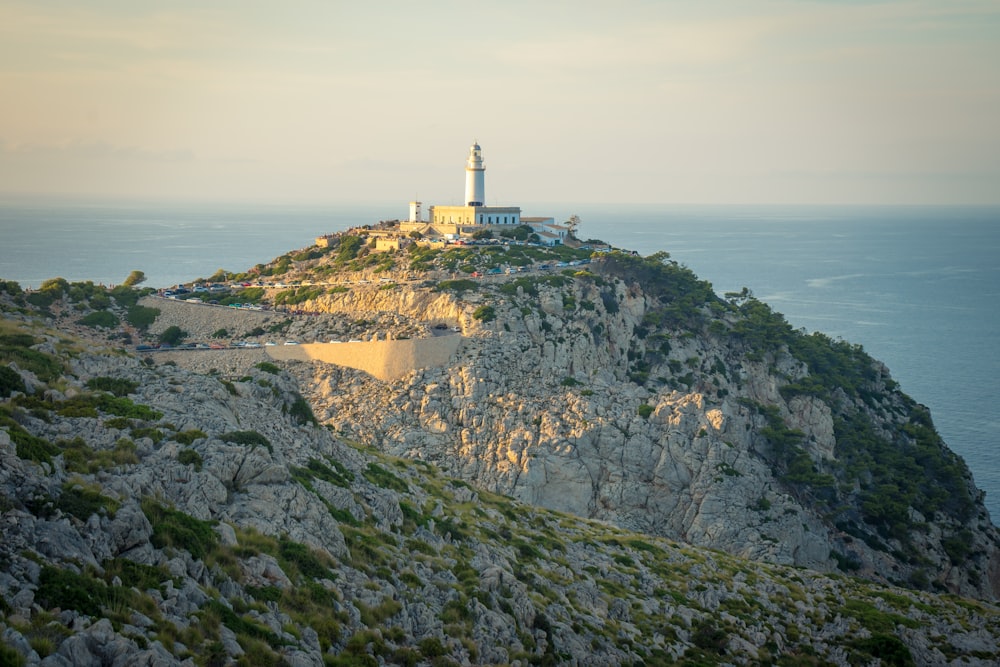 a lighthouse on top of a mountain overlooking the ocean