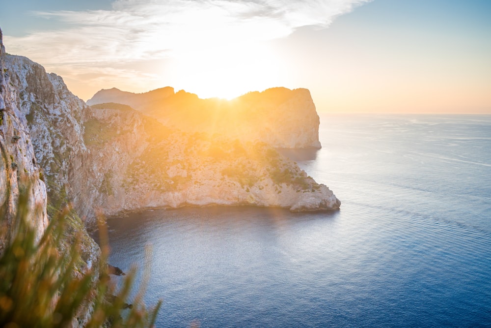 a person standing on a cliff overlooking the ocean