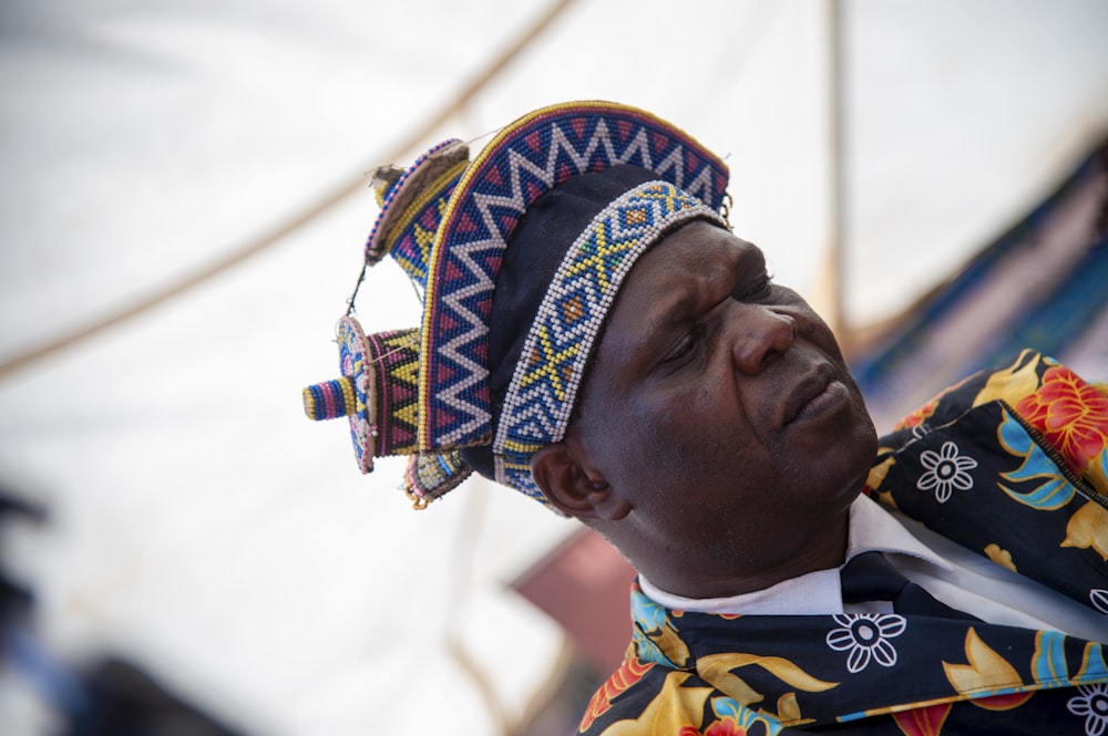 a man wearing a colorful hat and a tie