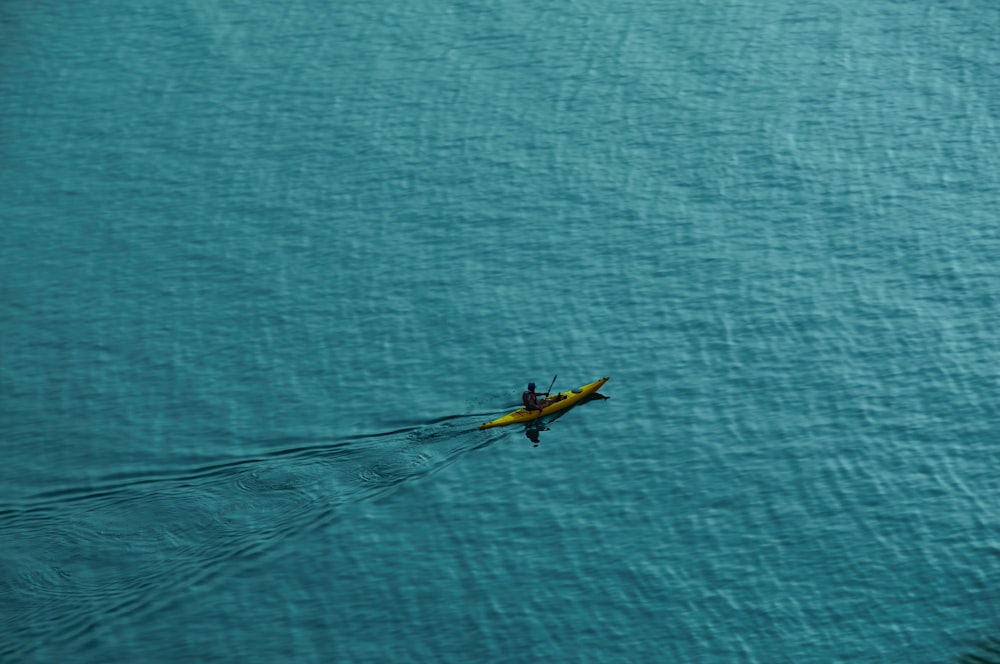 a person in a kayak in the middle of the ocean