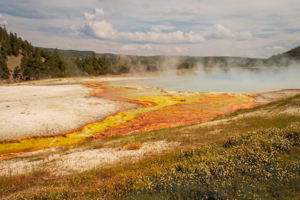 a large body of water with steam rising from it