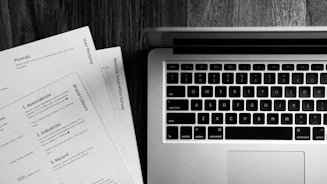 a laptop computer sitting on top of a wooden desk