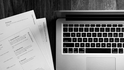 a laptop computer sitting on top of a wooden desk