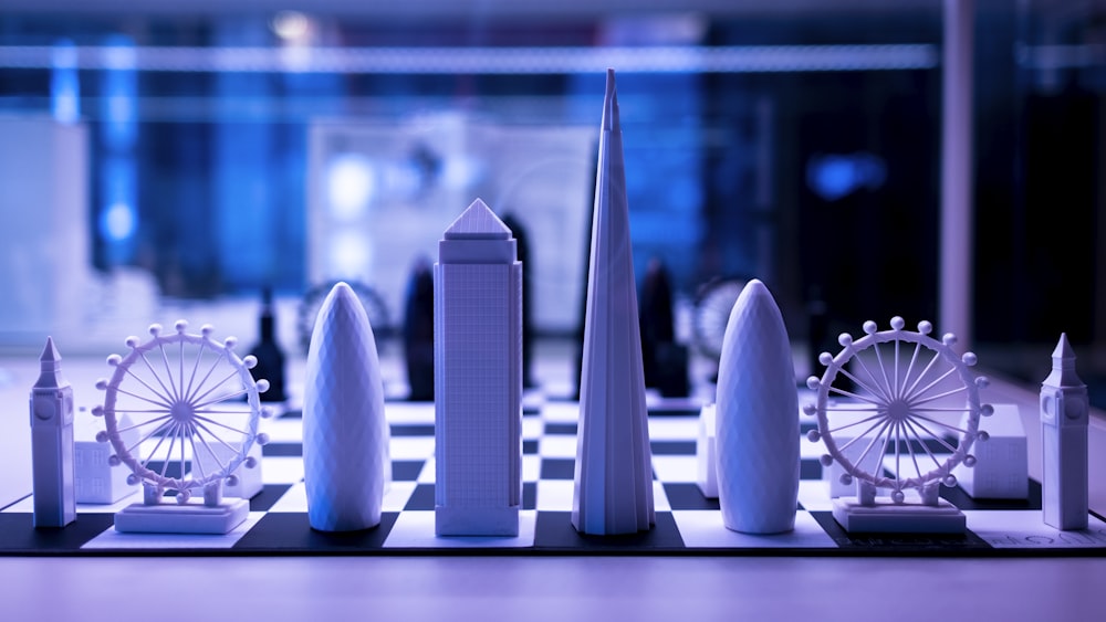 a chess board with miniature buildings and a ferris wheel