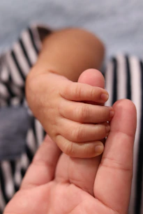 Murdered by Darkness Image  holding a baby's hand in their left hand