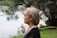 a woman with blonde hair standing in front of a body of water
