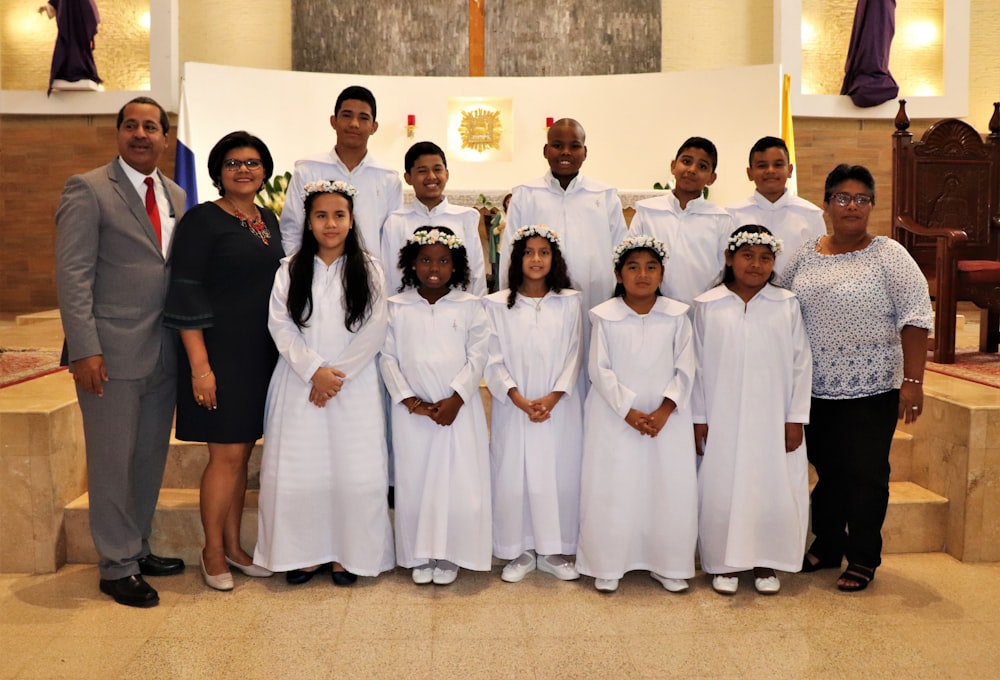 a group of people dressed in white posing for a picture