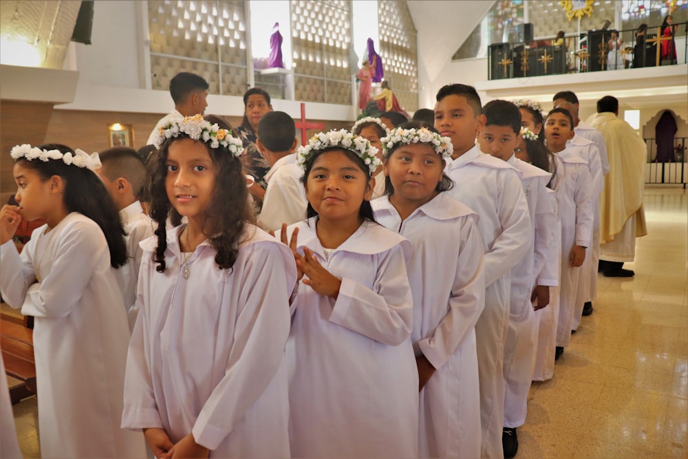 a group of young children standing next to each other