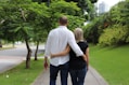 a man and a woman walking down a sidewalk