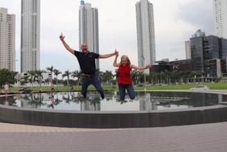 a man and a woman standing in front of a fountain