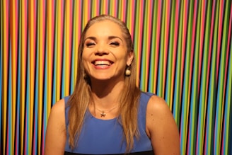 a woman standing in front of a colorful wall