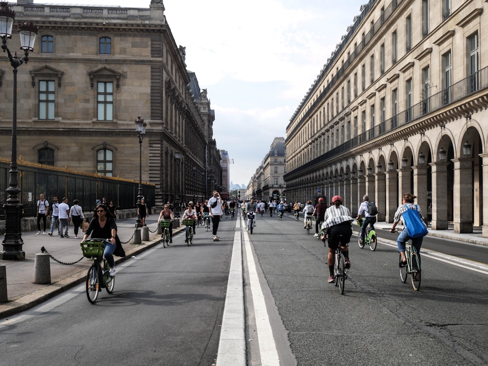 a group of people riding bikes down a street