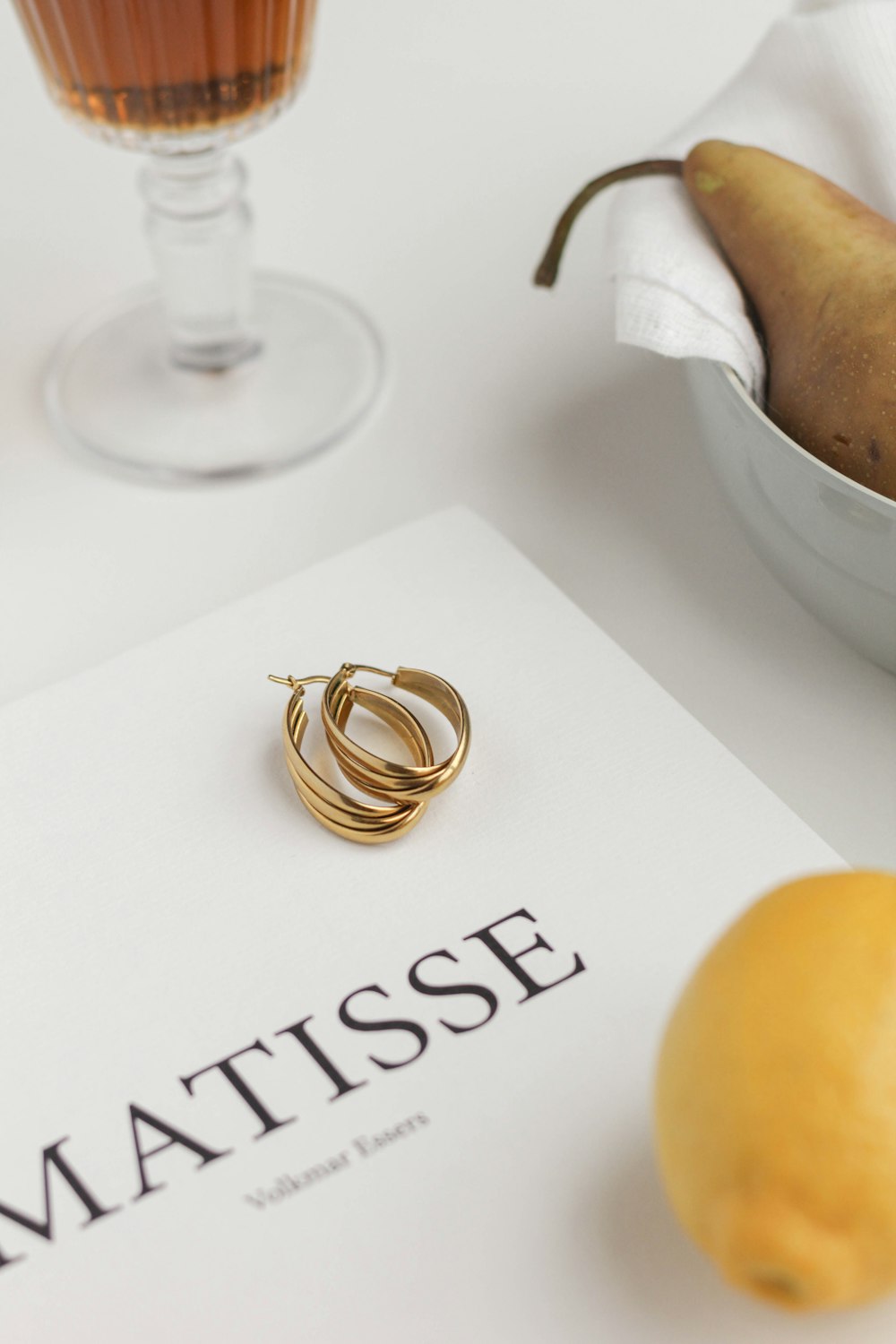 a pear and a glass of tea on a table