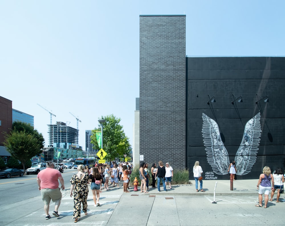 a group of people standing in front of a building