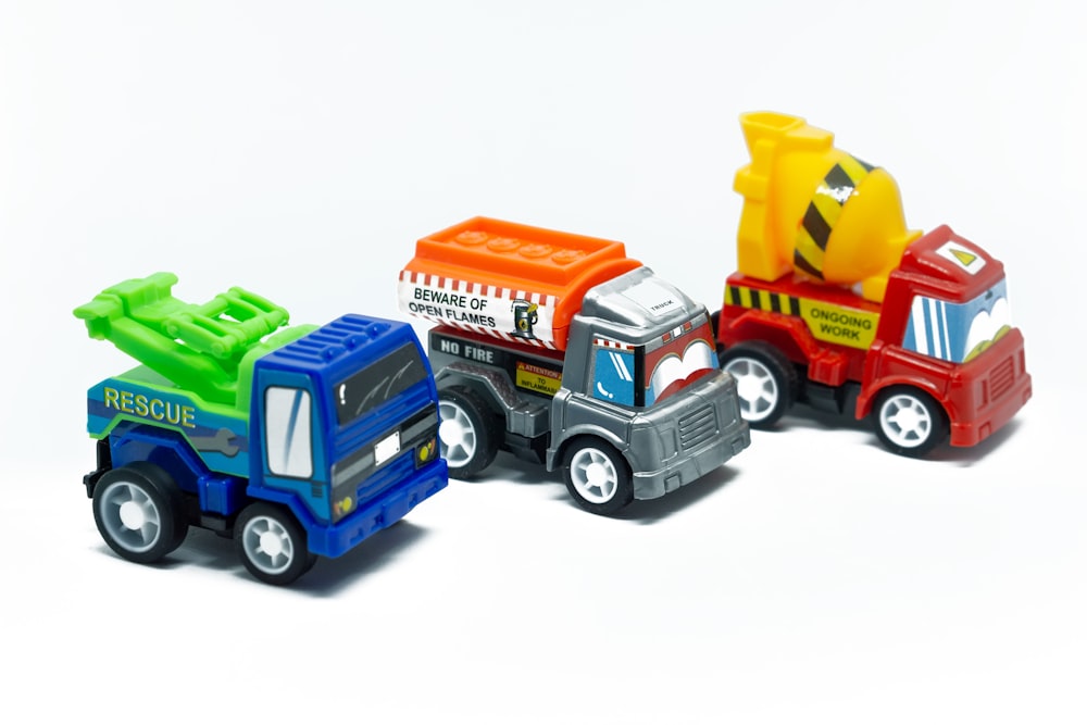 a group of toy trucks sitting next to each other