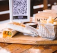 a basket of food sitting on top of a wooden table