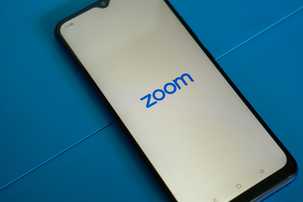 a close up of a cell phone with the zoom logo on it