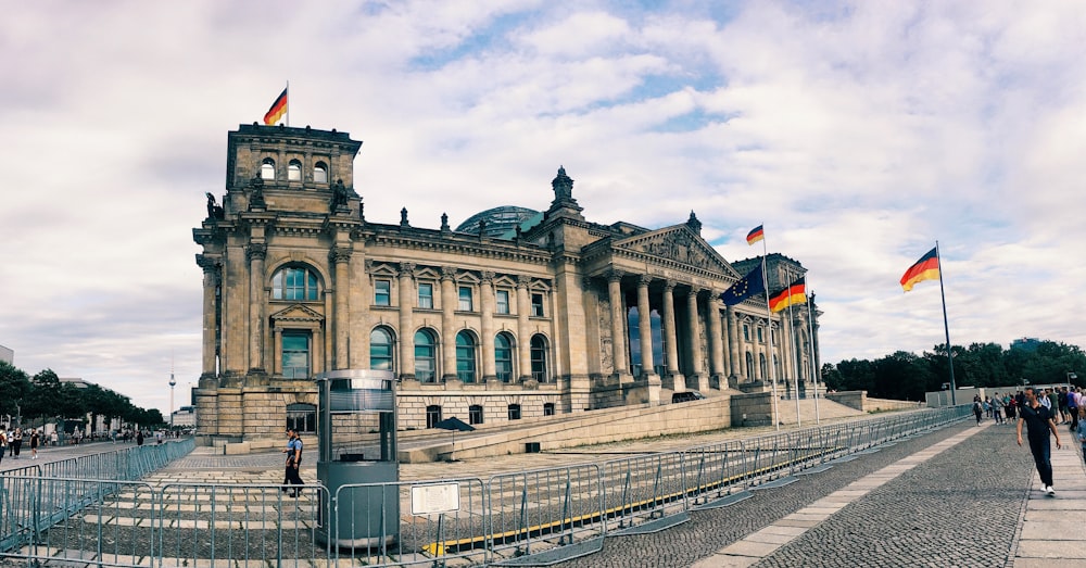 a large building with flags flying in front of it