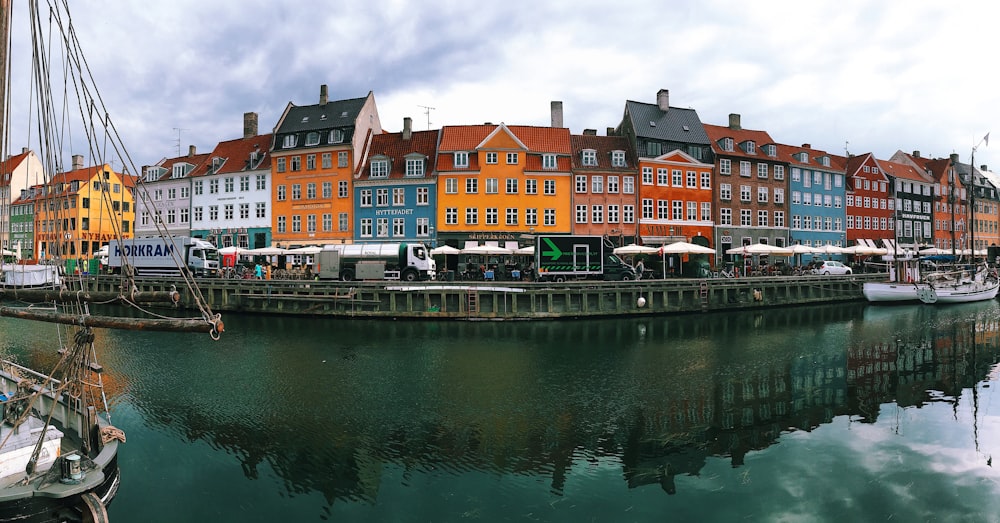 a harbor filled with lots of boats next to tall buildings