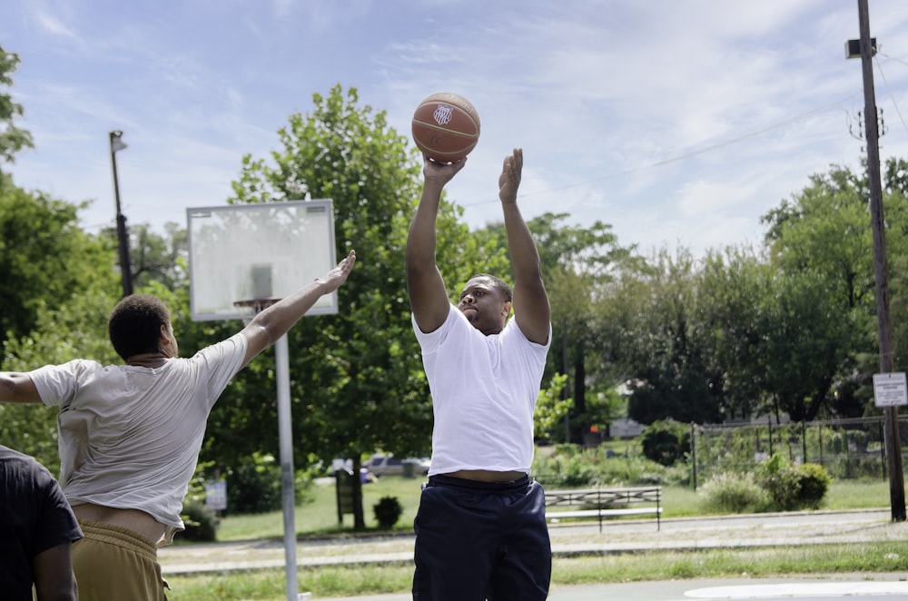 a couple of men playing a game of basketball