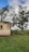 a small building sitting on top of a lush green field