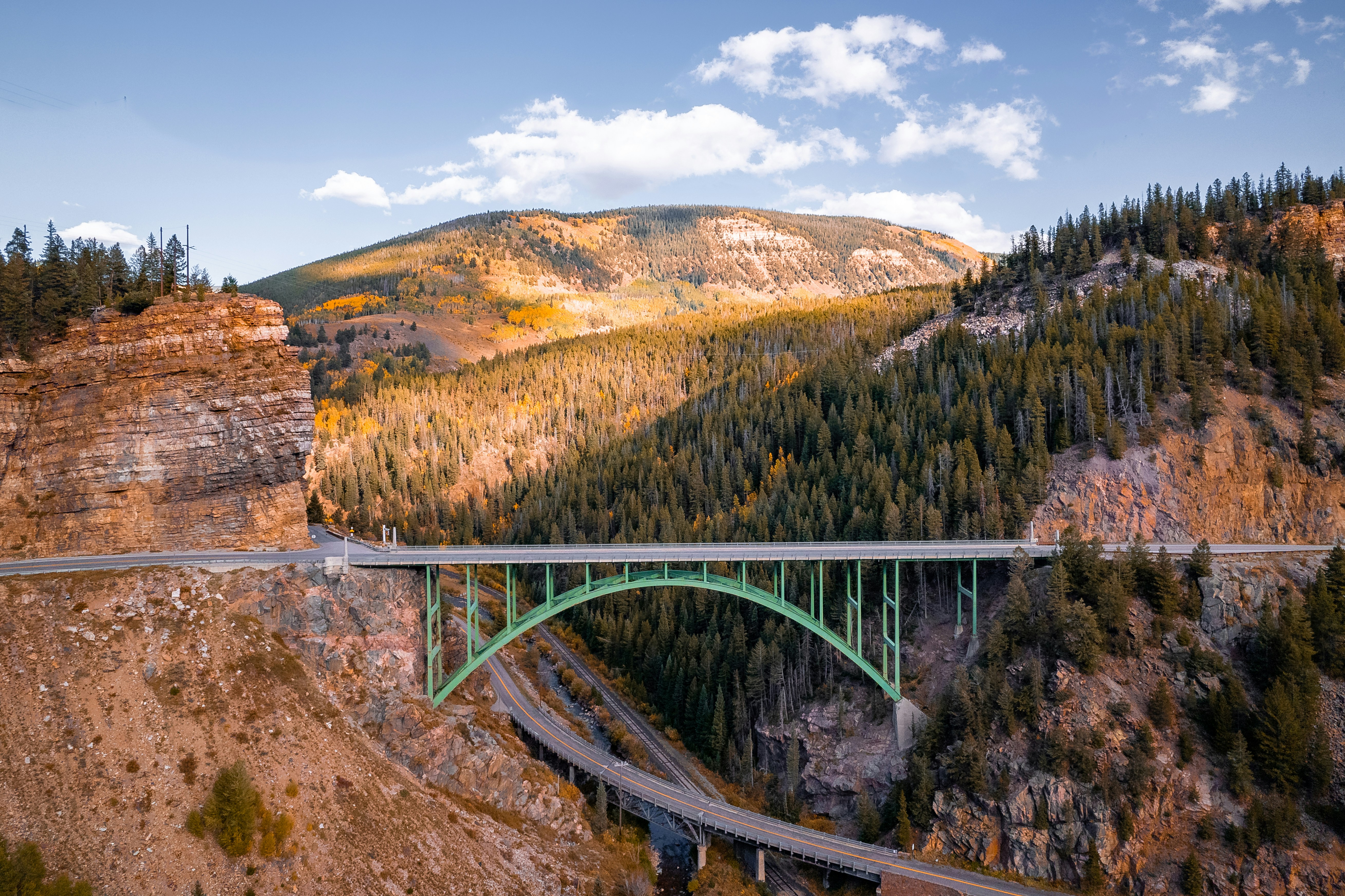 a bridge over a canyon with a mountain in the background
