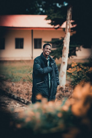 Smiling faces of people receiving coats and blankets during a mobile outreach event in an urban park