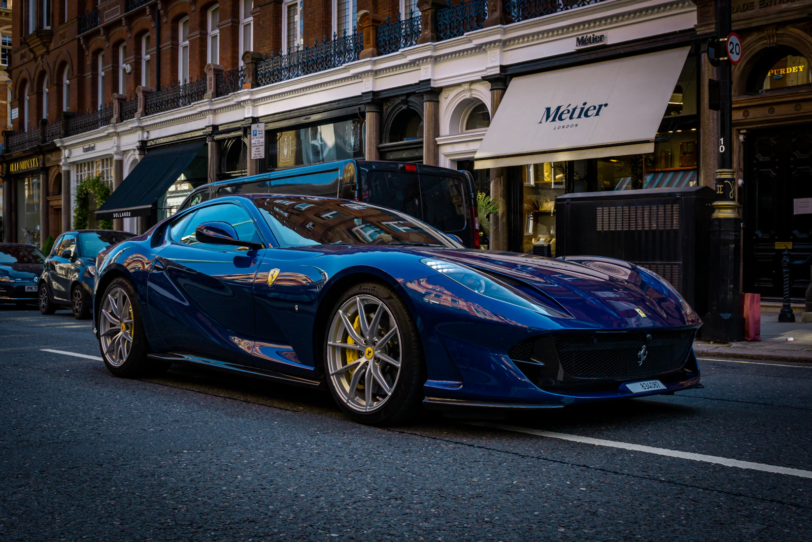 Blue Ferrari 812 Superfast parked on a city street