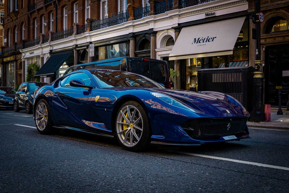 a blue sports car parked on the side of the road