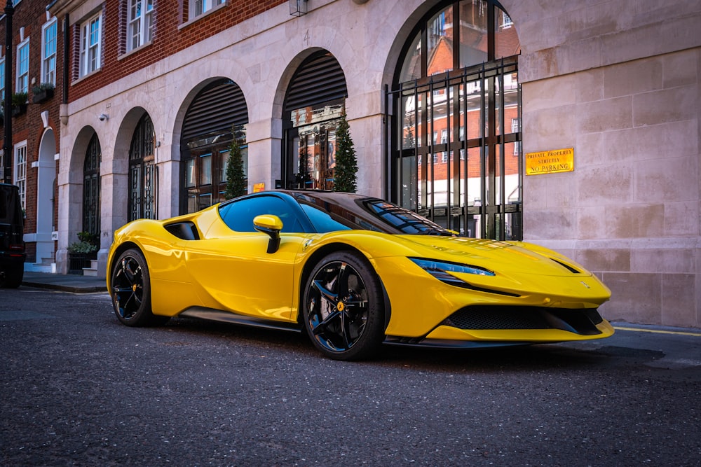 a yellow sports car parked in front of a building