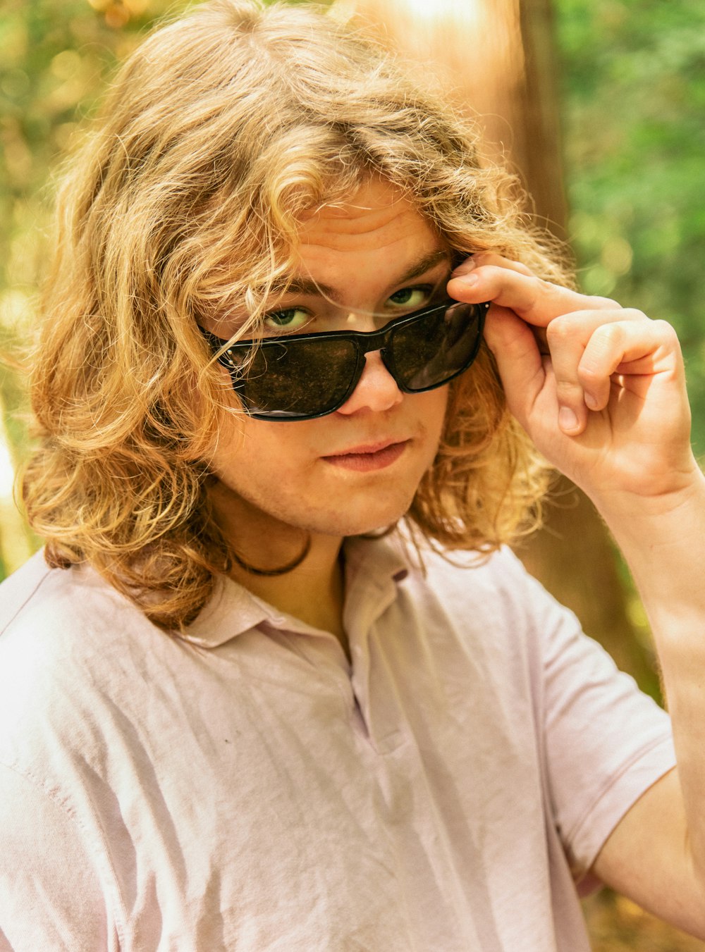 a man in a white shirt and black sunglasses