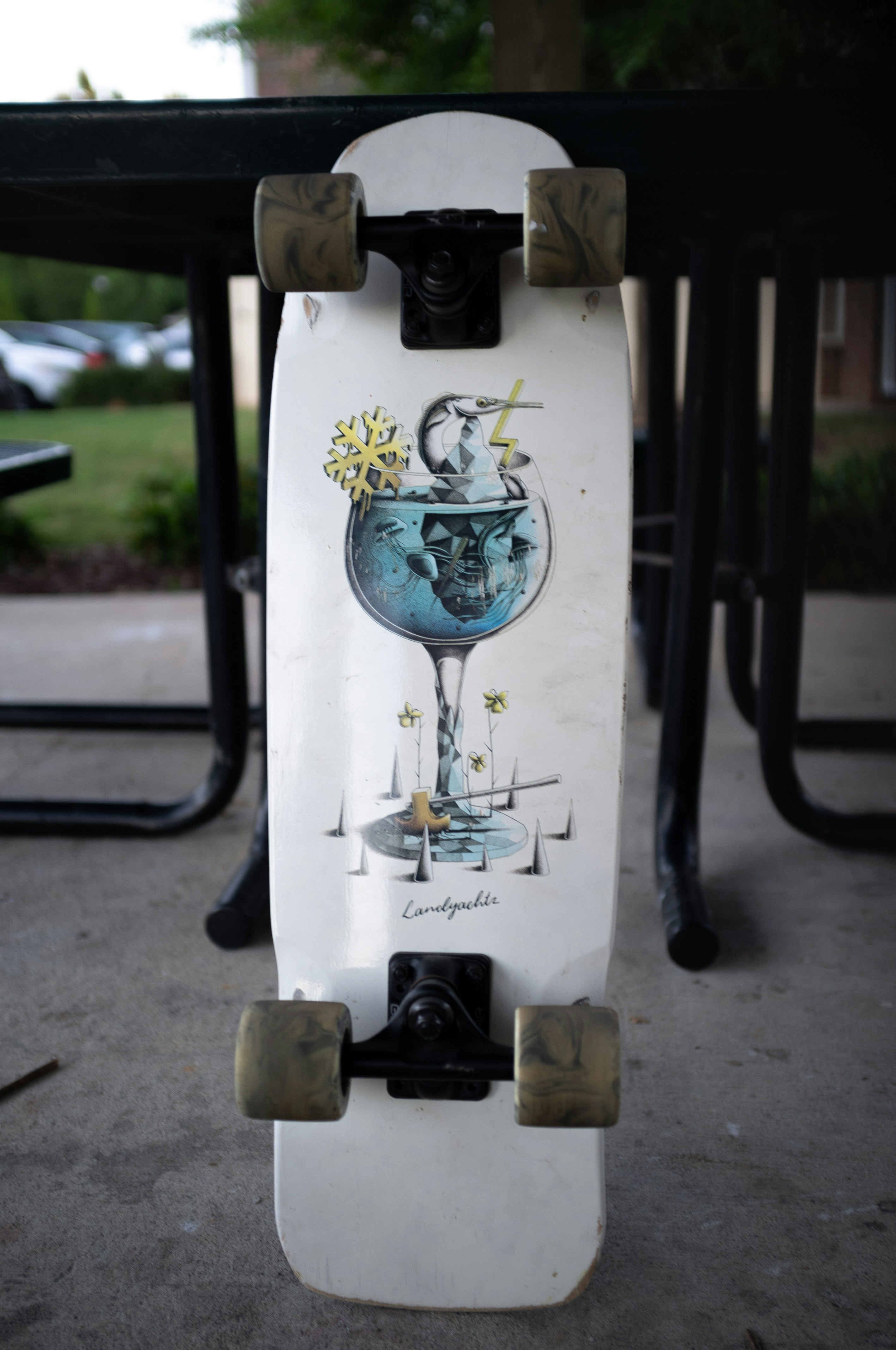 a skateboard with a picture of a wine glass on it
