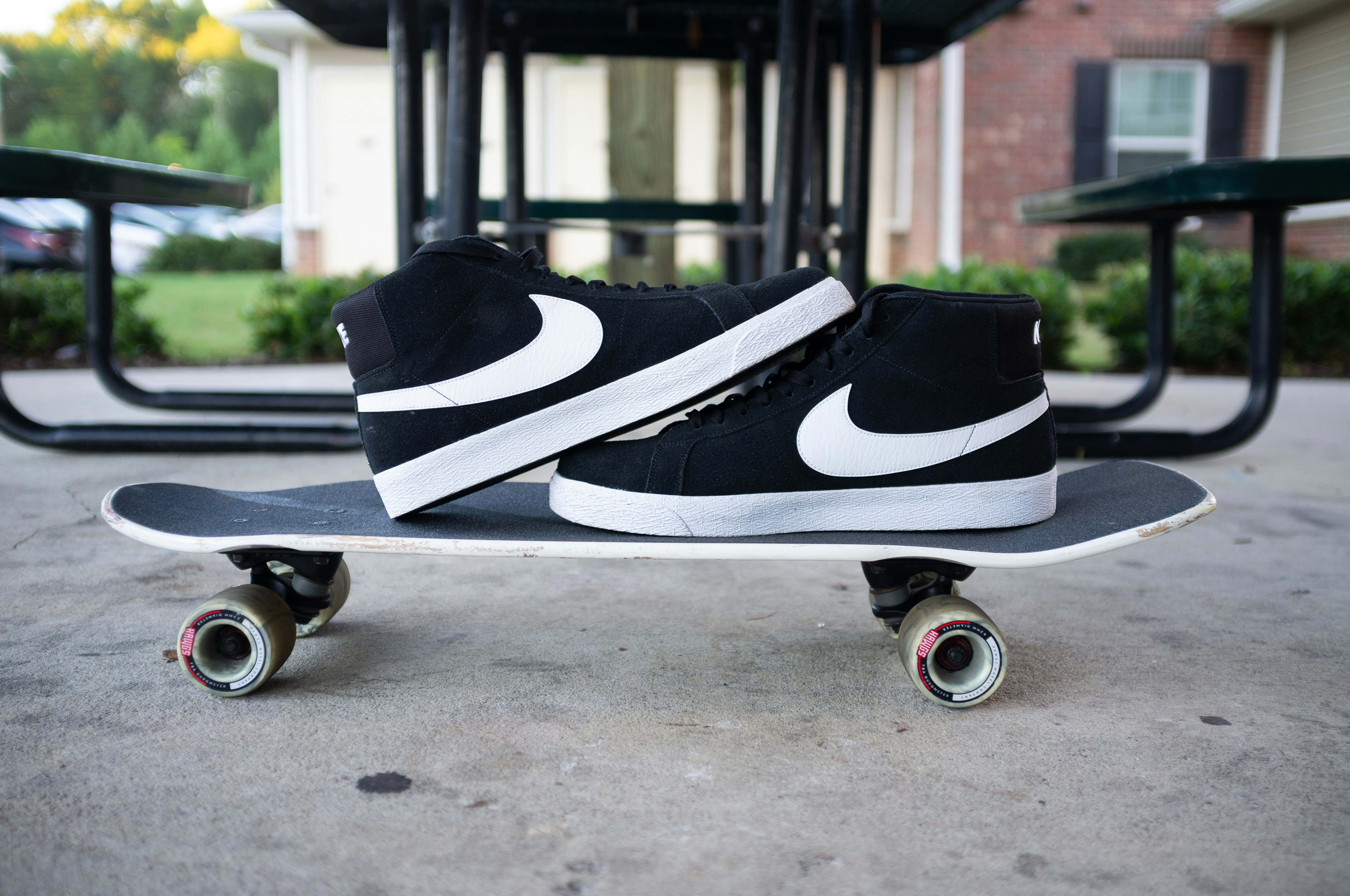 a pair of sneakers sitting on top of a skateboard