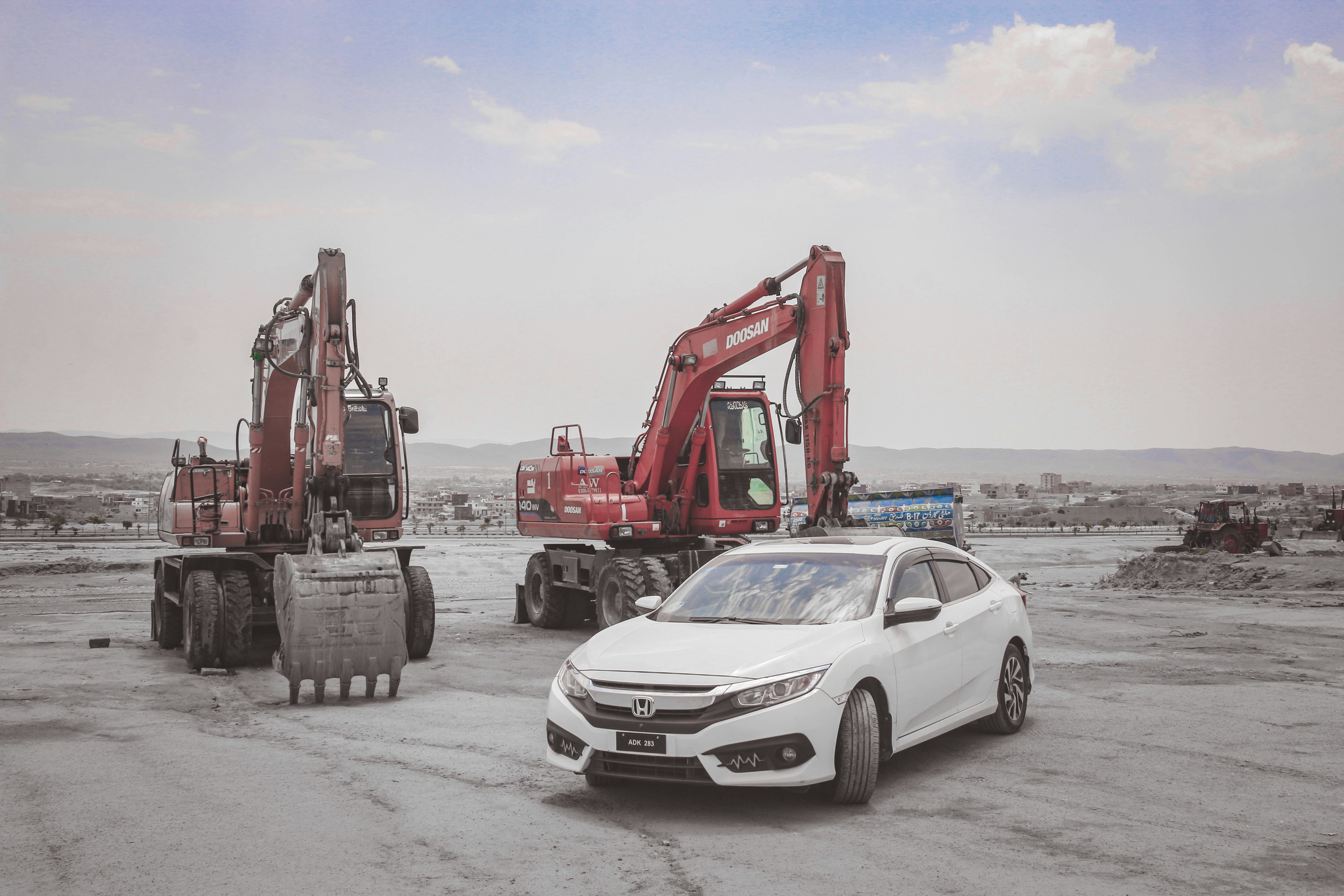 a white car parked in a lot next to a tractor, All Hail to the King <3 