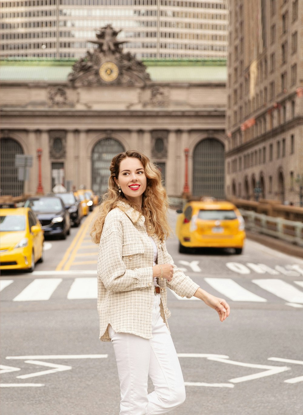 a woman standing in the middle of a street