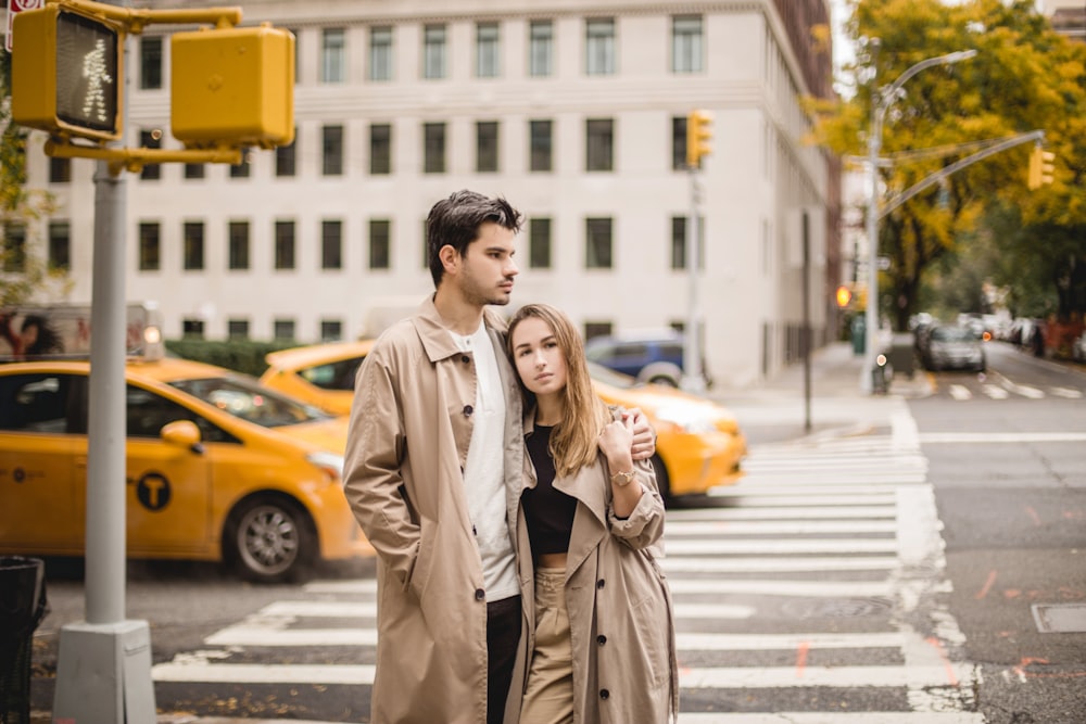 a man and a woman standing on a street corner