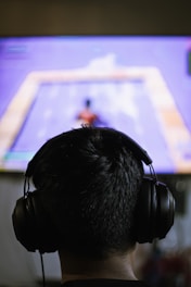 a person wearing headphones watching a television