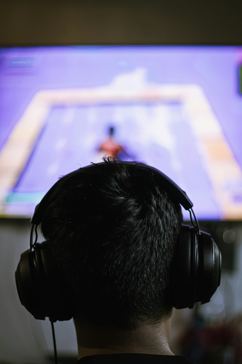 a person wearing headphones watching a television
