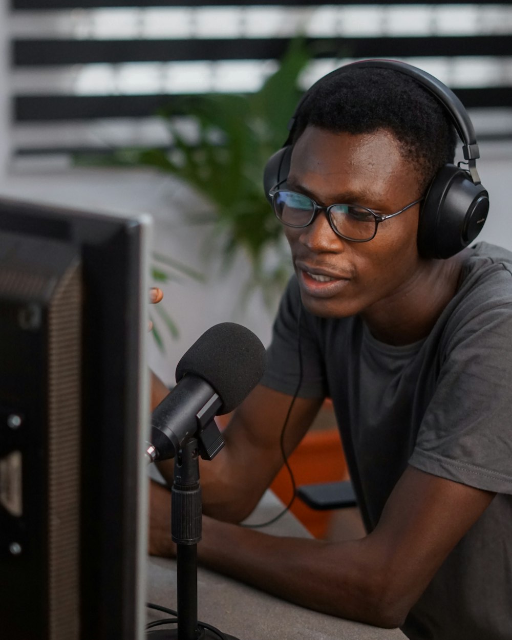 a man wearing headphones sitting in front of a computer