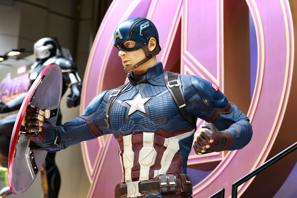 a statue of captain america holding a shield