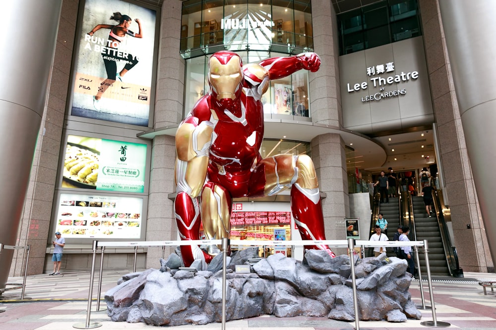 a statue of iron man in front of a building
