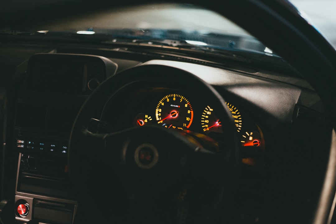 the dashboard of a car with a dash light on,
