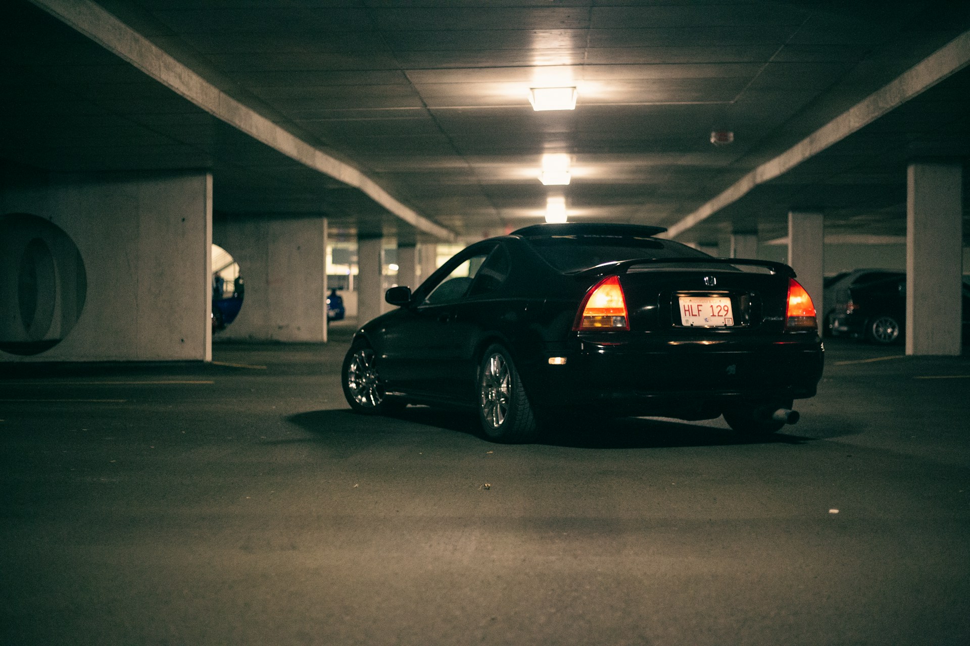 a black car parked in a parking garage