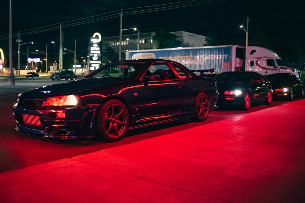 a couple of cars parked next to each other on a street